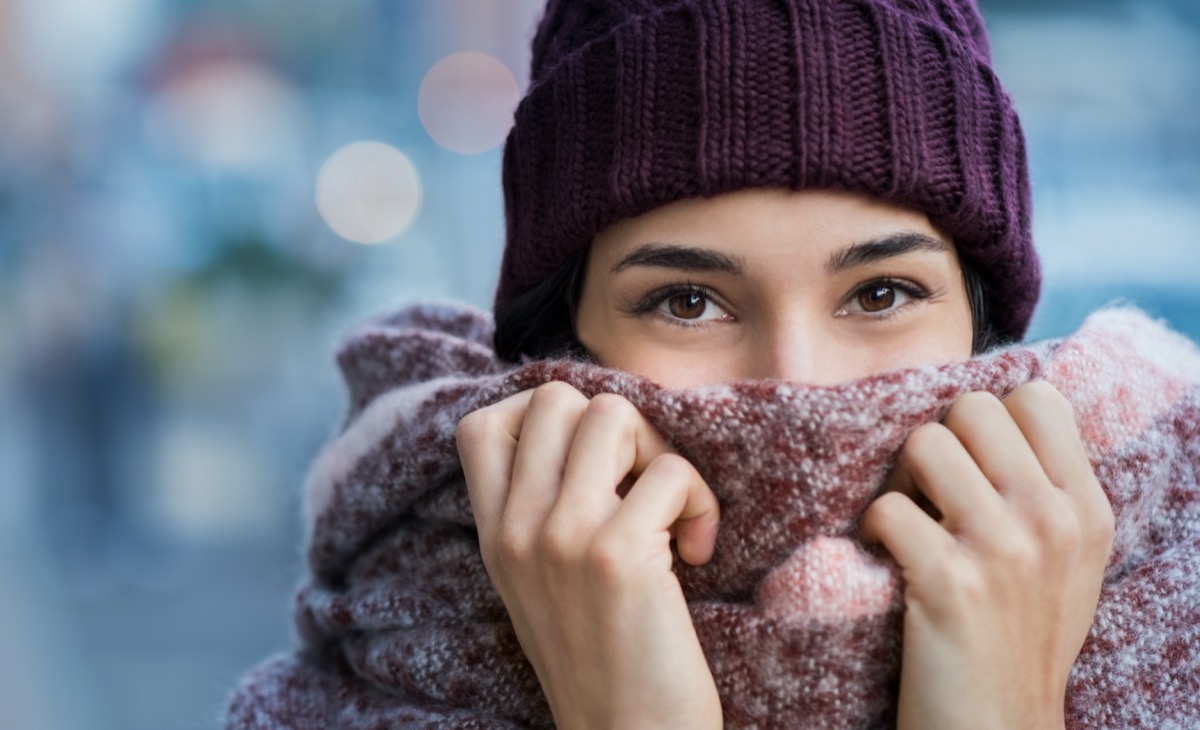 woman covering face with woolen