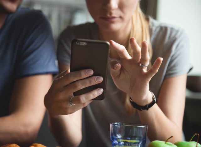 Woman tracking her calorie and food intake on app on phone