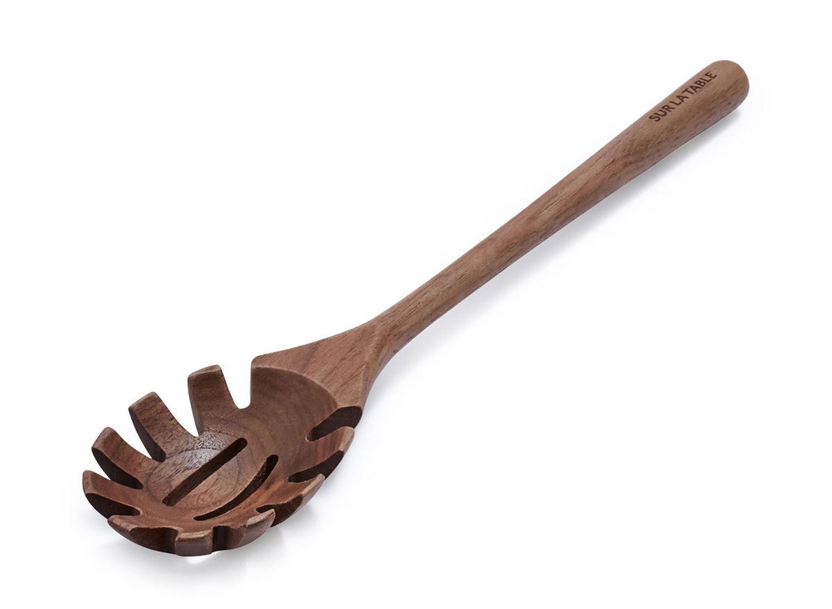wooden straining spoon on white background