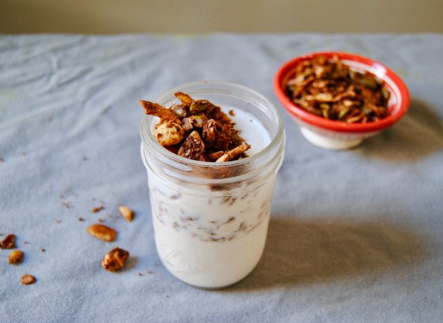 paleo breakfast yogurt and granola smoothie in mason jar with granola in background