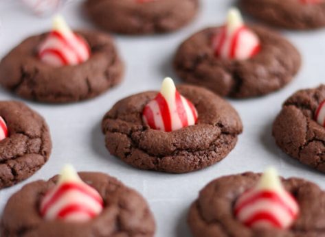 Chocolate cookies with a peppermint kiss on parchment paper