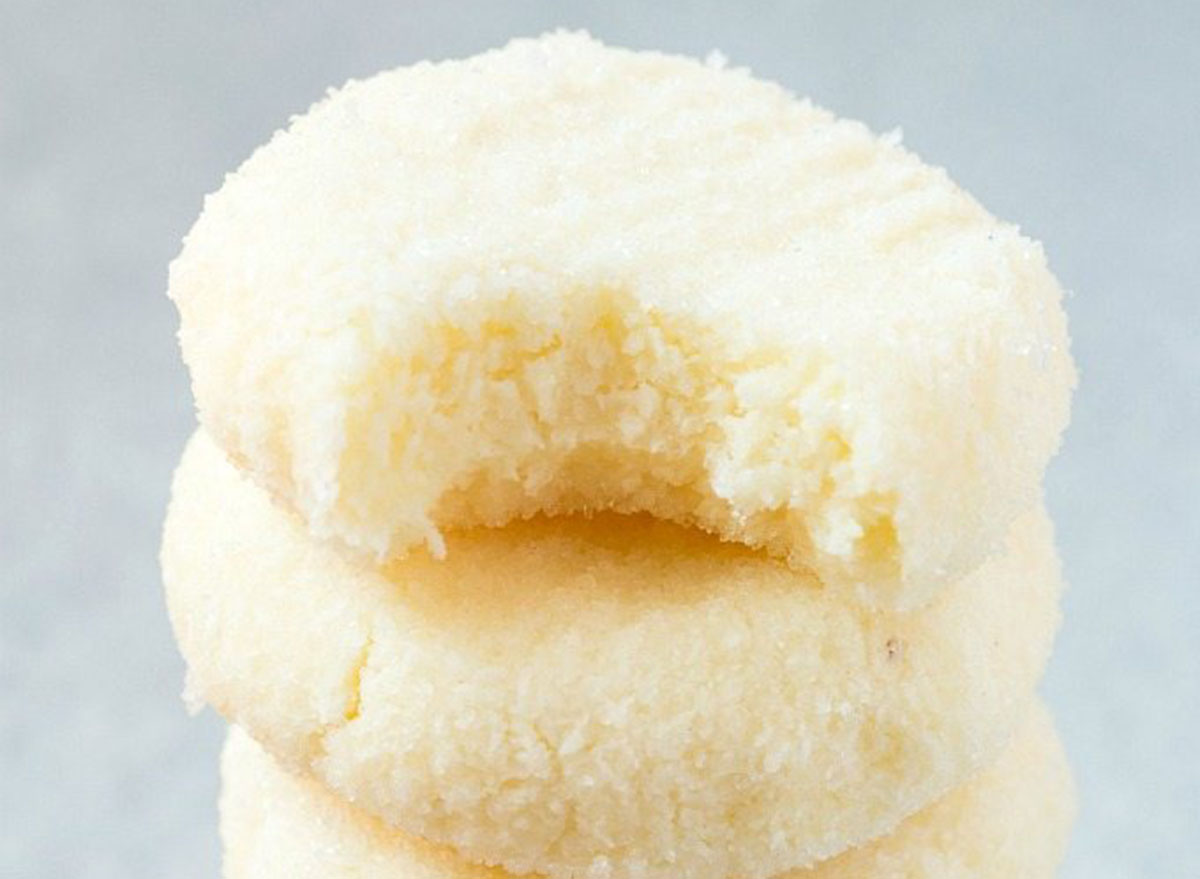 Coconut snowball cookies piled on top of each other
