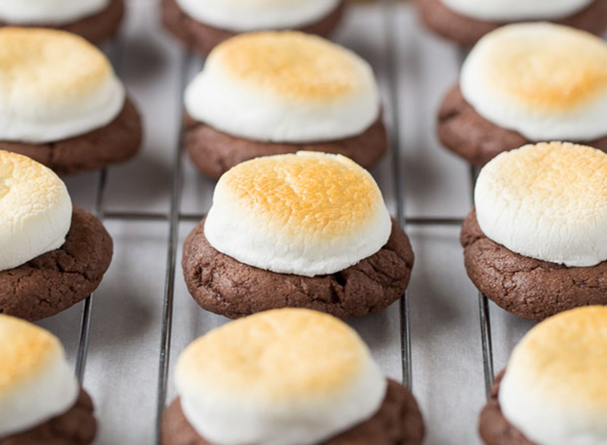 Toasted marshmallows on chocolate cookies sitting on a cooling rack