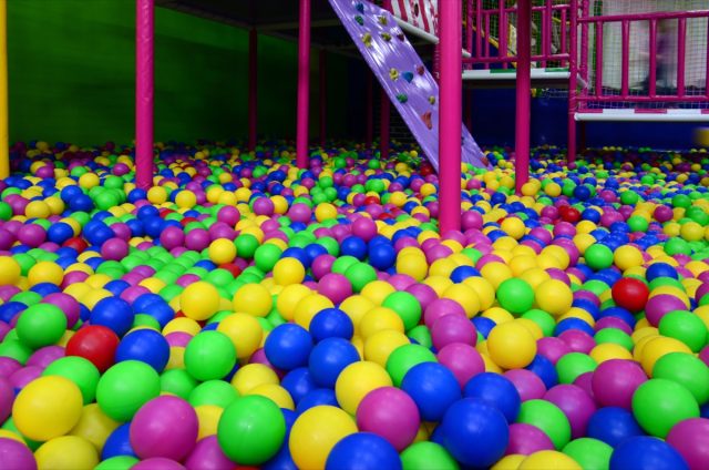 Many colorful plastic balls in a kids' ballpit at a playground