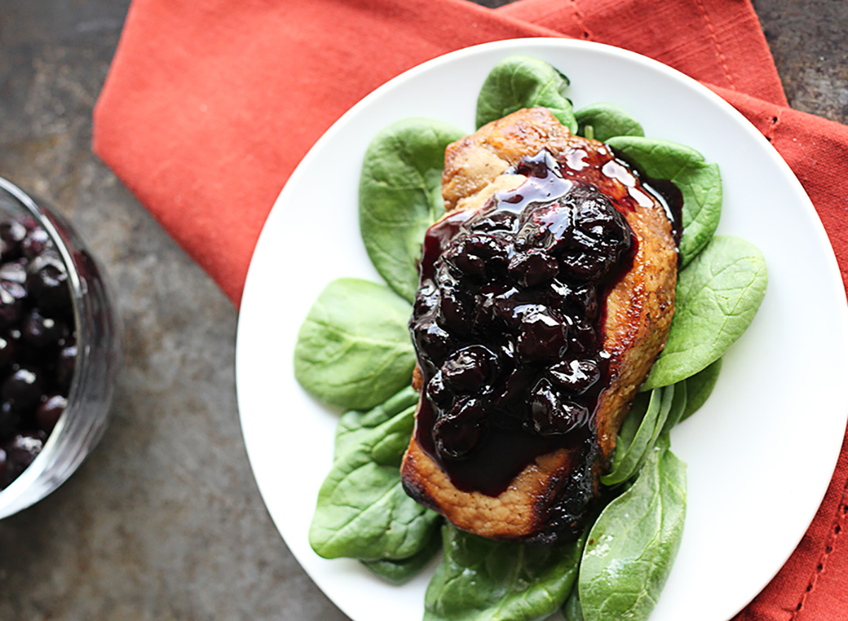 blueberry balsamic pork chop on plate with glaze