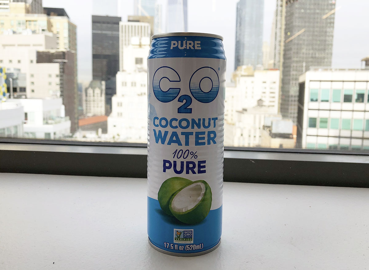 c 2 o 100 percent pure coconut water can by window