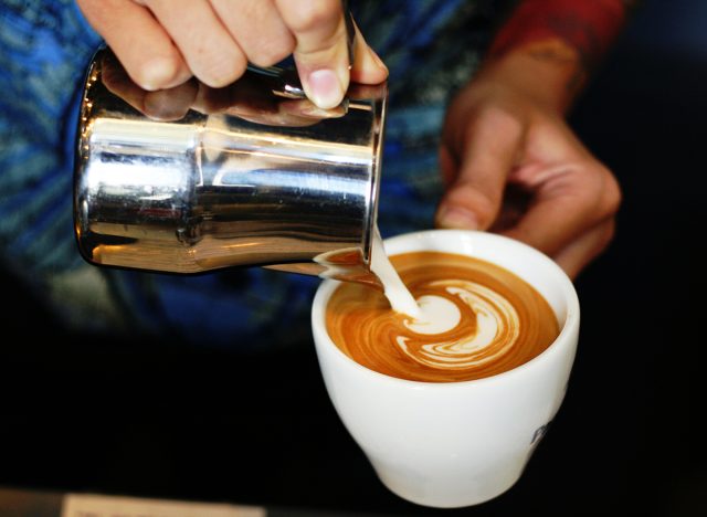 barista making a cappuccino