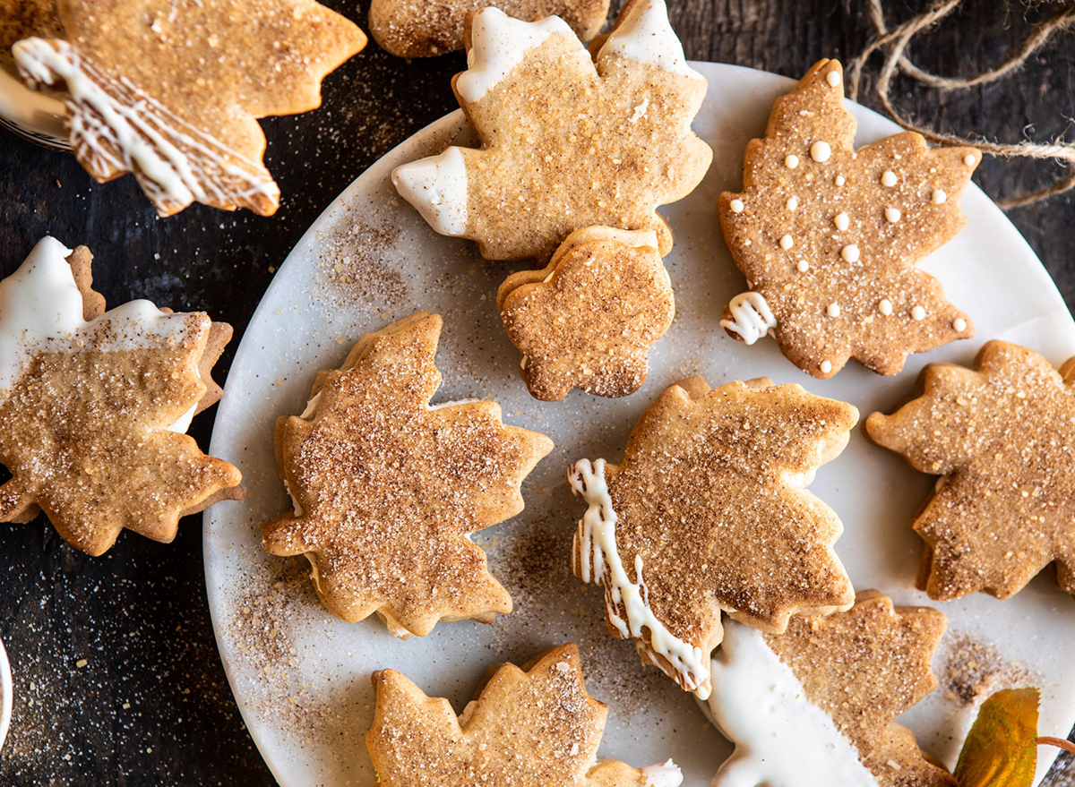 chai spiced maple sugar cookies shaped like maple leaves with brown sugar dusting