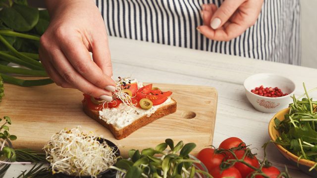 Chef adding toppings to toast for a high cholesterol diet plan