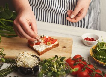Chef adding toppings to toast for a high cholesterol diet plan