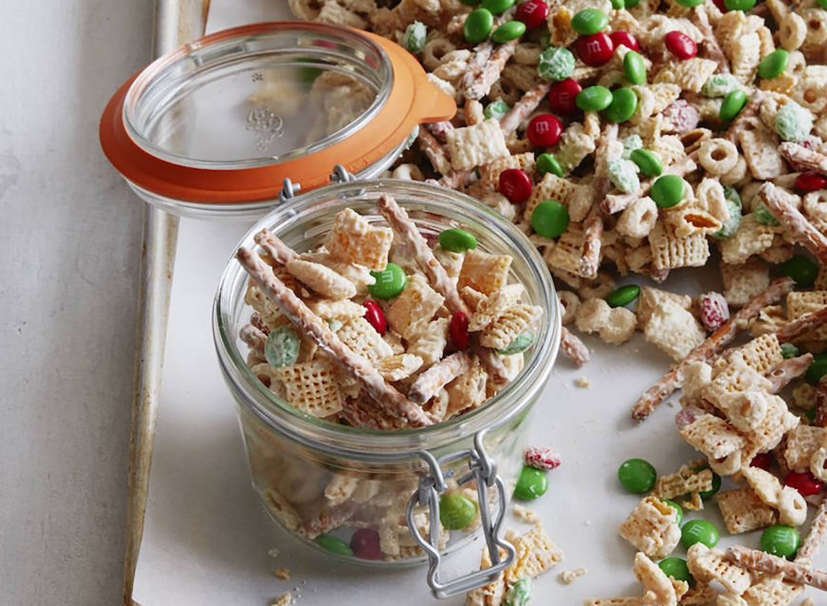 christmas chex mix with white chocolate and m and ms in glass jar