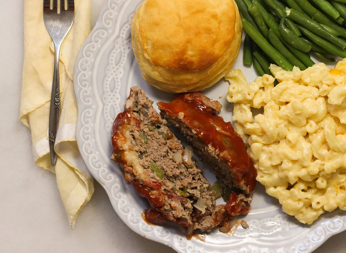 Slices of meatloaf on a plate with sides.