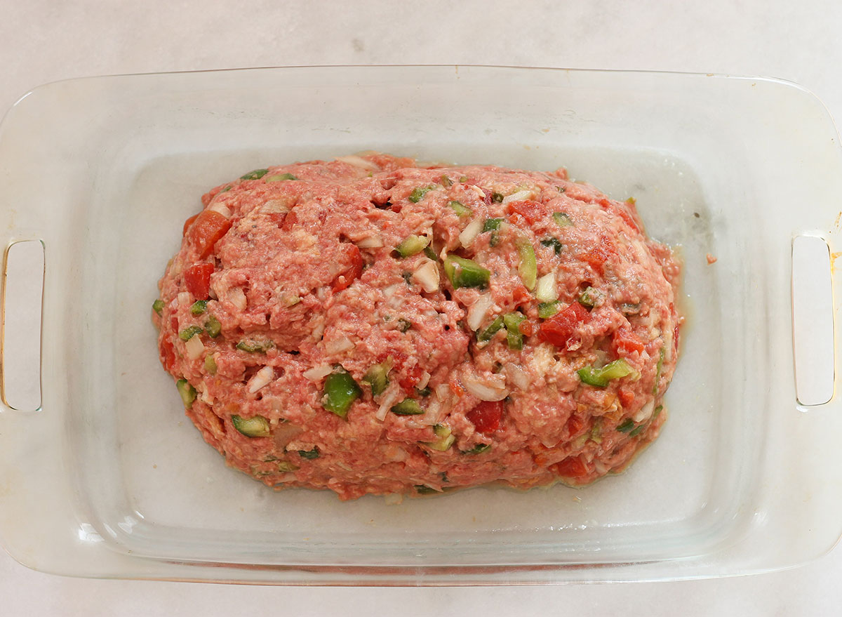 Formed meatloaf in a deep casserole dish.
