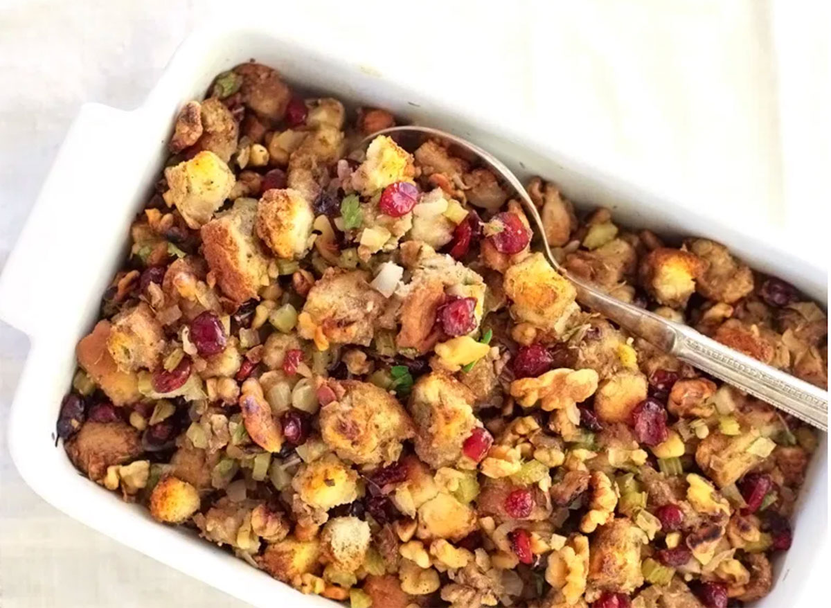 cranberry walnut thanksgiving stuffing in white serving dish