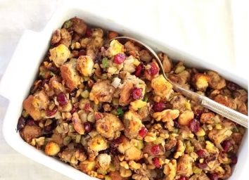 cranberry walnut thanksgiving stuffing in white serving dish