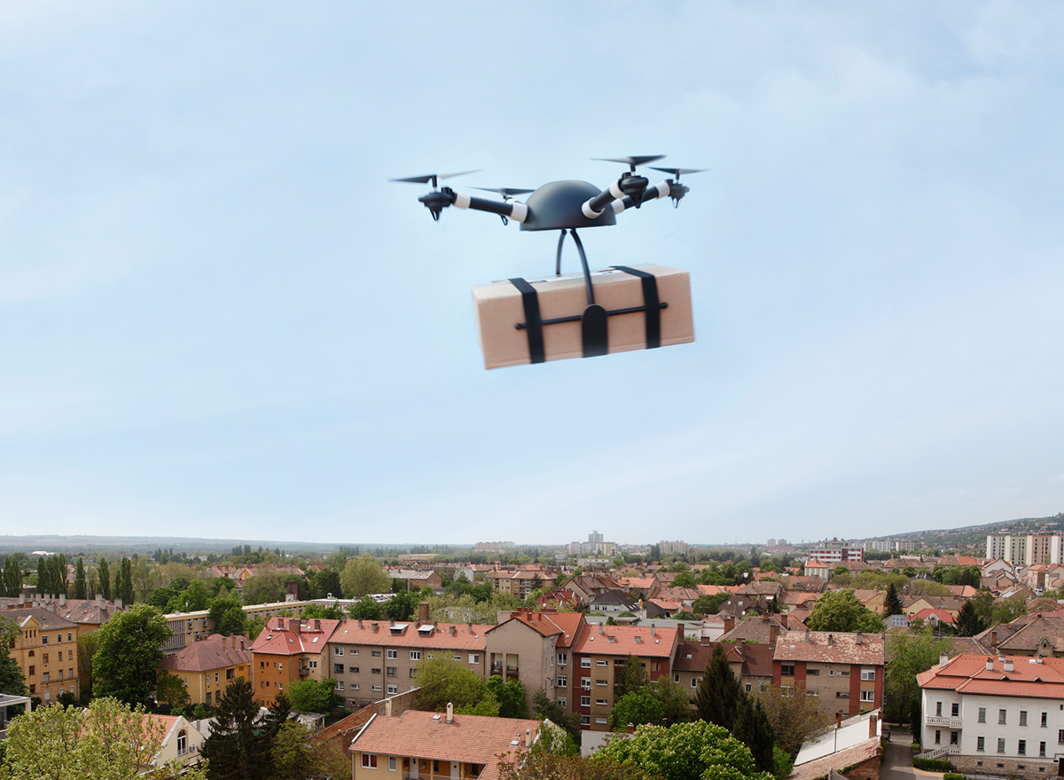 drone delivery box flying above neighborhood