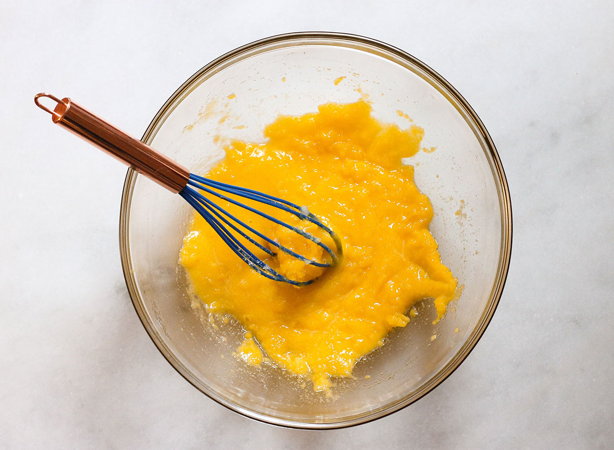 whisking sugar and eggs in a bowl