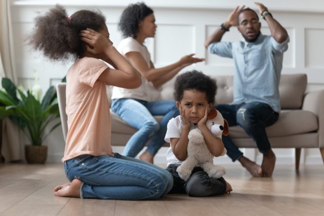 kids closing ears hurt by parents fighting arguing at home