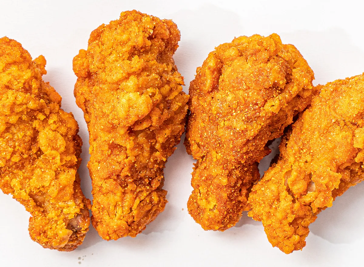 four fried chicken wings on a white background