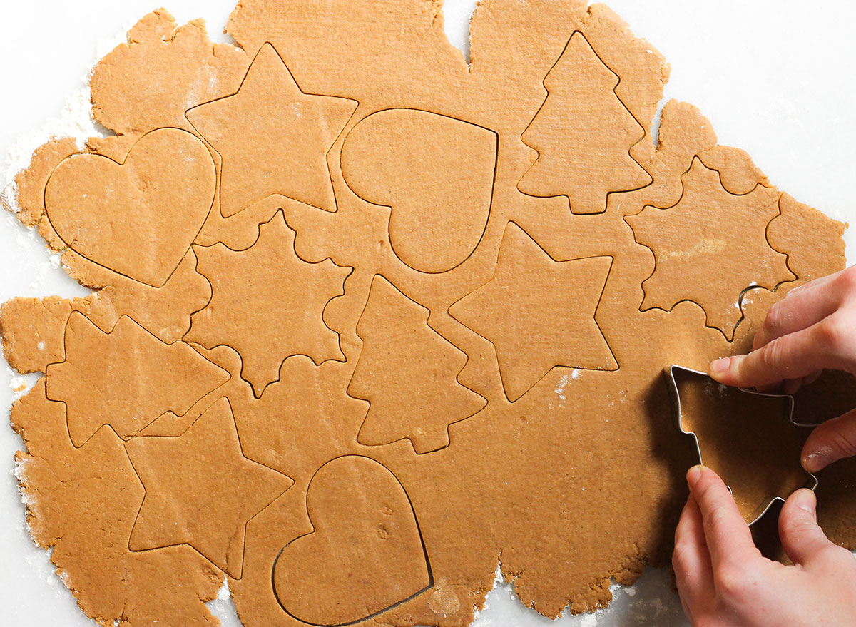 gingerbread cookies cut into shapes with cookie cutter