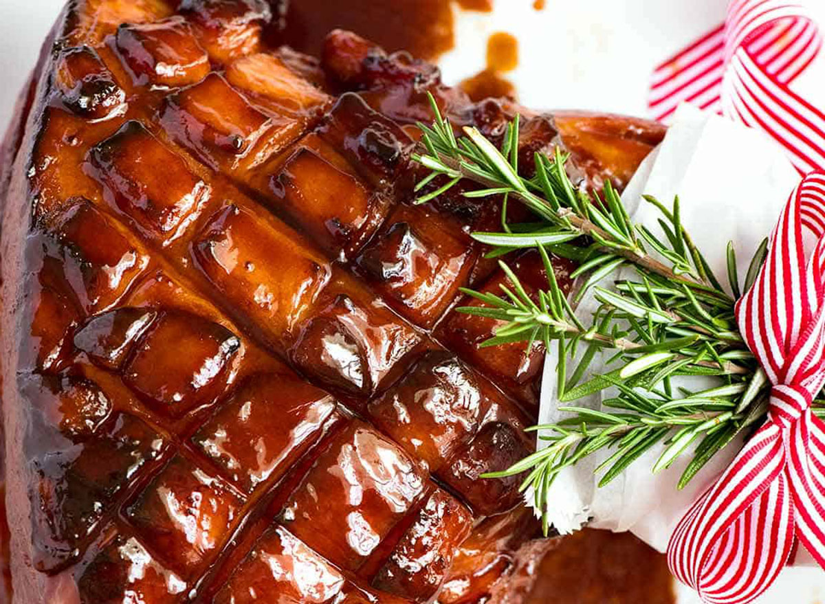 brown sugar glazed bone in ham with crosscut and rosemary garnish