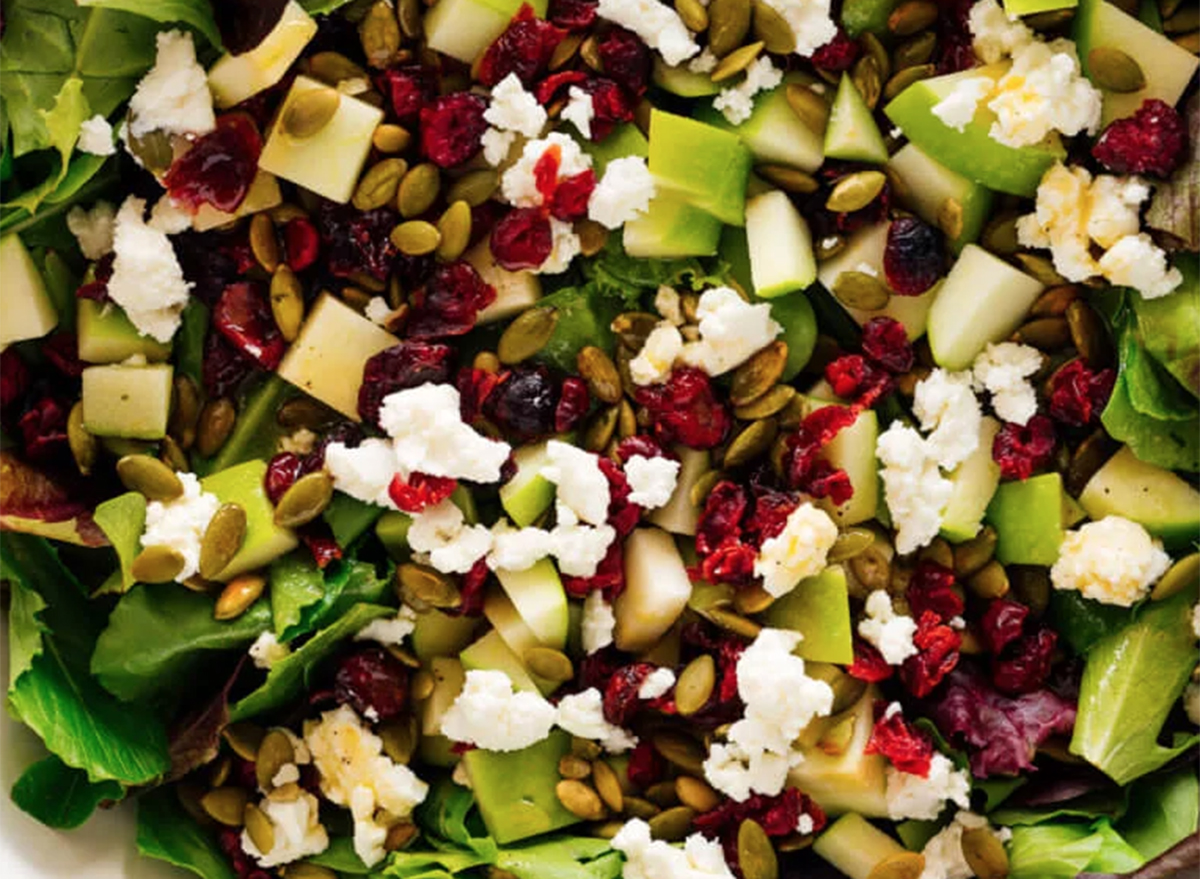 green salad with apples, cranberries, and pepitas