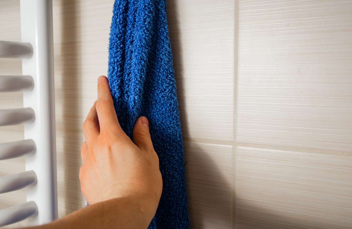 The hand reaches for the towel