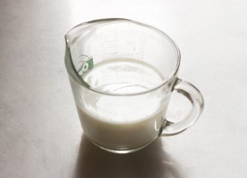 Cup of homemade buttermilk on a marble counter