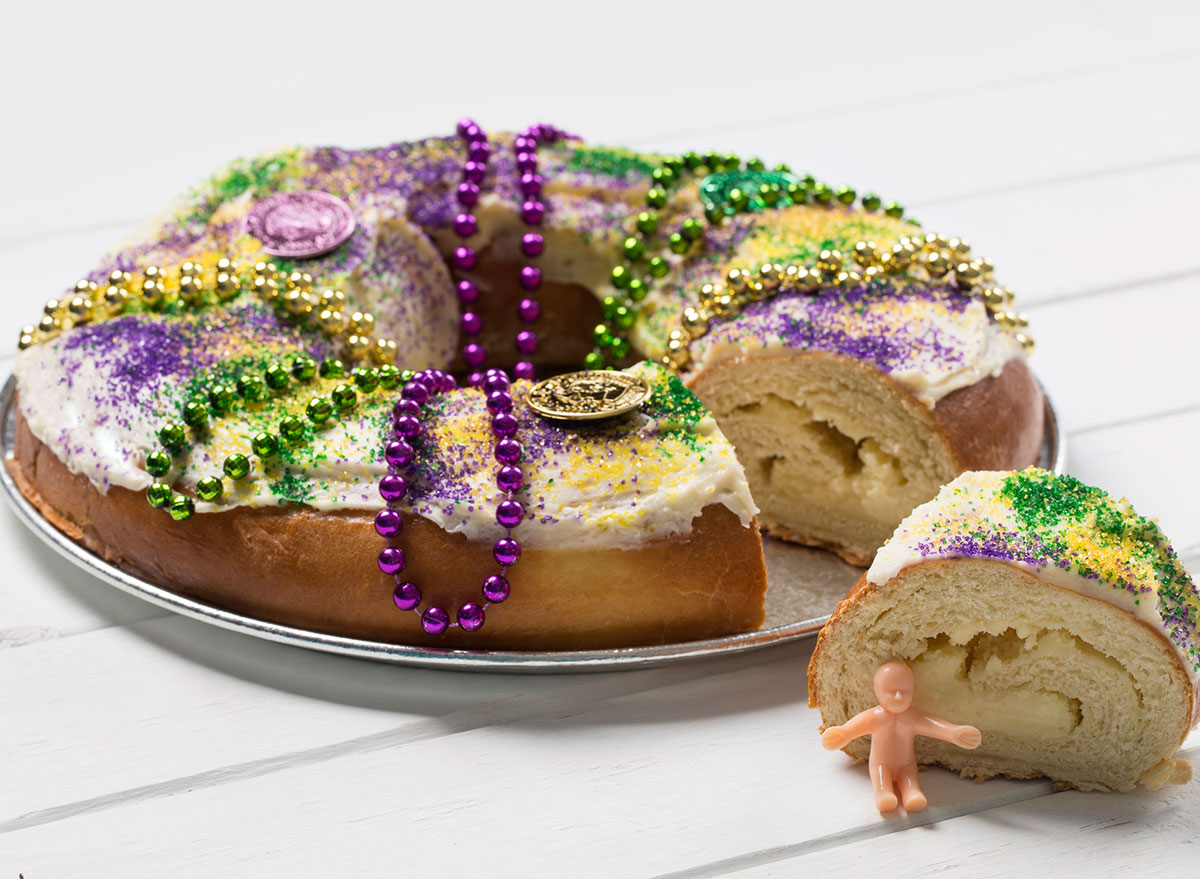 king cake with slice and plastic baby