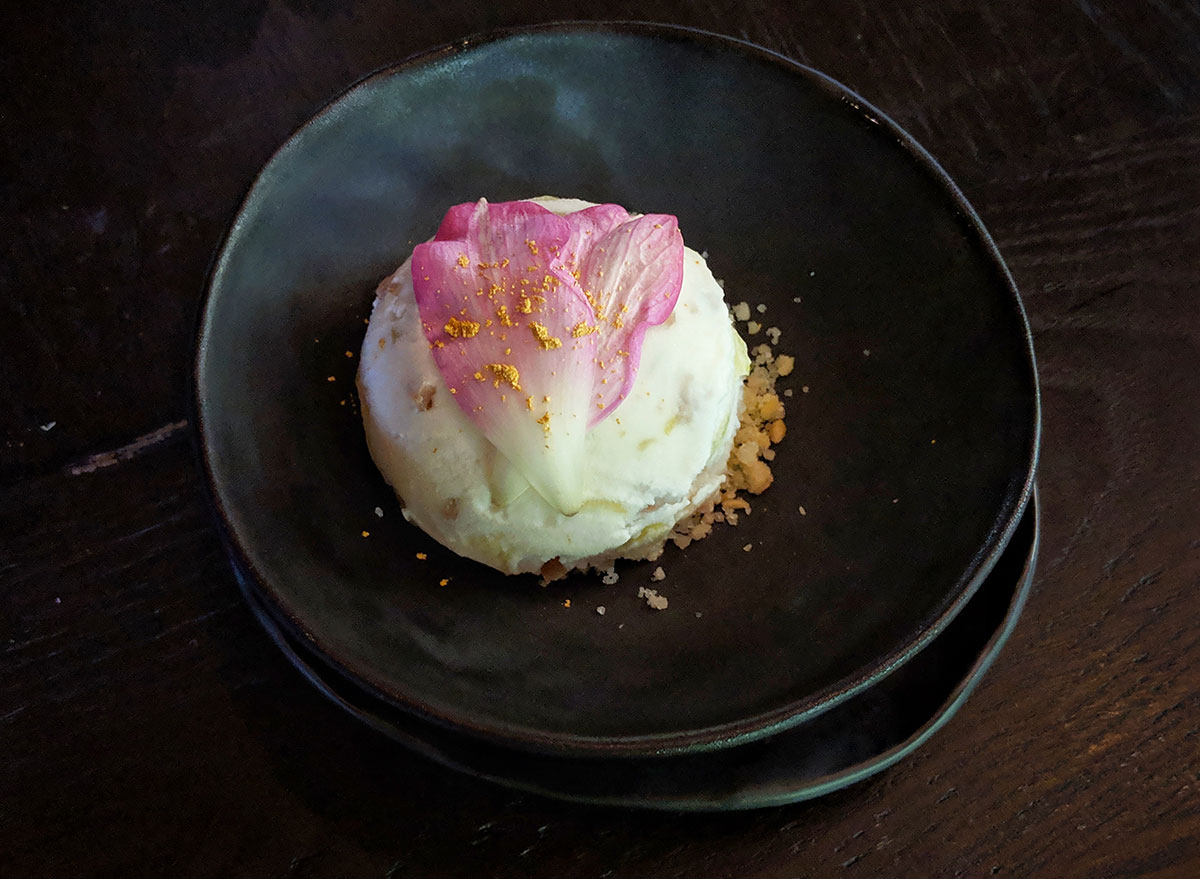 Ice cream dessert on a plate with lotus flower on top