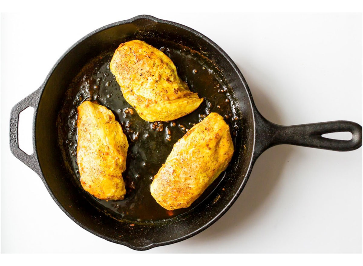 maple turmeric chicken breasts in cast iron skillet