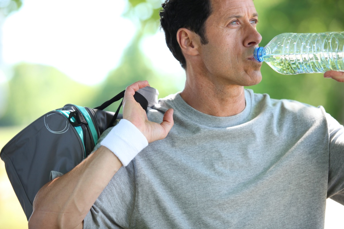 mature man drinking water from a bottle