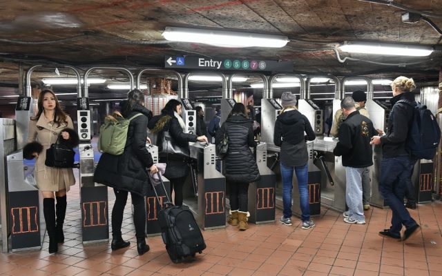 Commuters pass through a ticket barrier