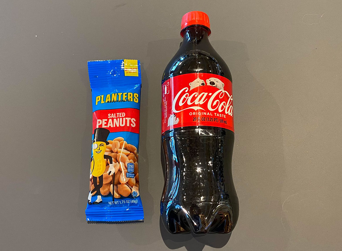 bottle of coke and packet of peanuts