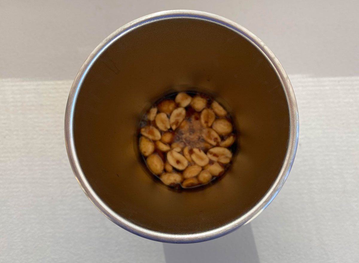 metal cup filled with coke and peanuts