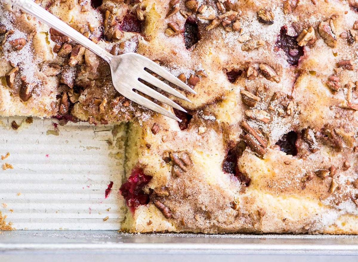 german kuchen dessert with plums and pecans in baking tray