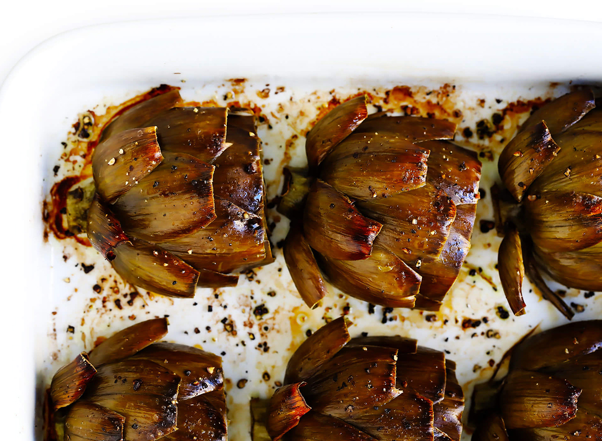 six roasted artichokes on baking tray