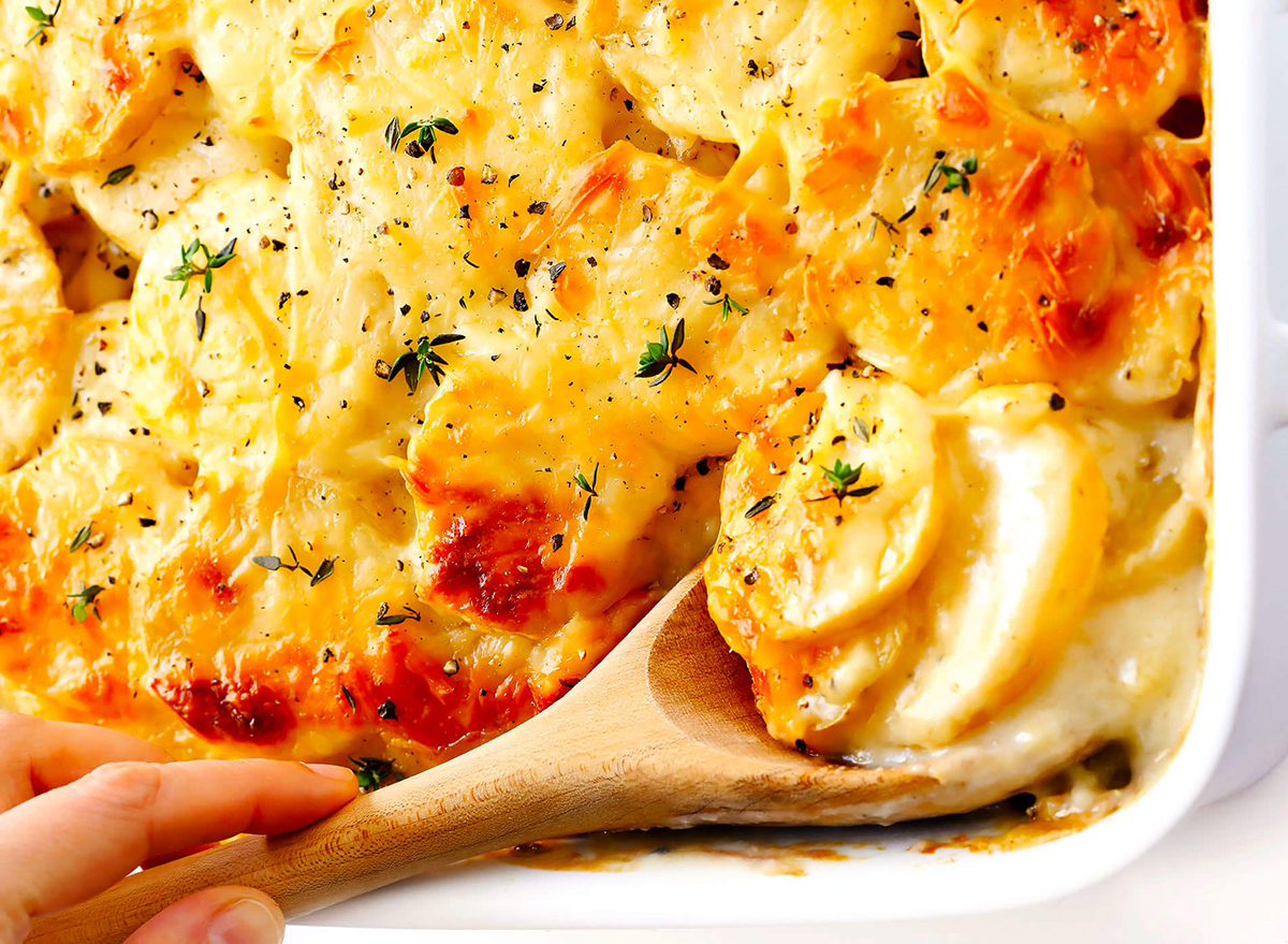 baking dish of scalloped potatoes sliced with cheese
