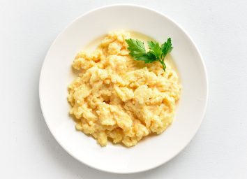 scrambled eggs on white plate with garnish