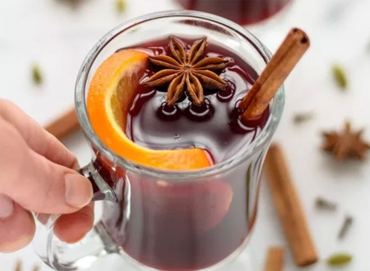 spiced mulled wine with orange peel and cinnamon stick in glass