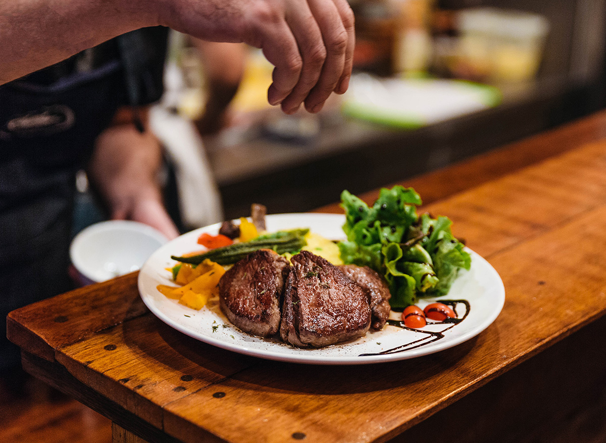 stir fried beef steak with veggies on a white plate