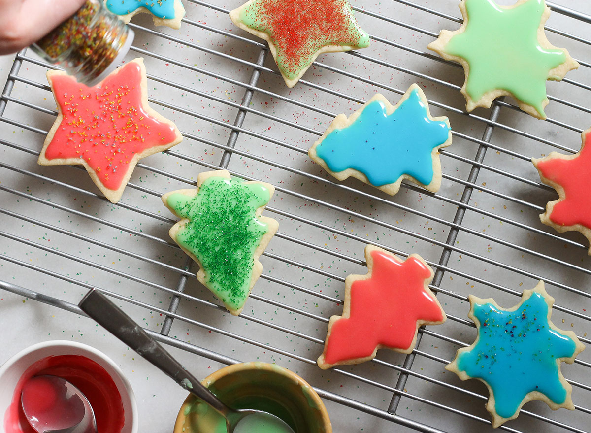 icing and decorating sugar cookies on a cooling rack