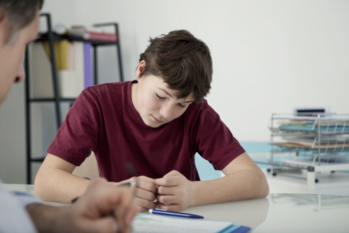Child psychologist working with upset teenager