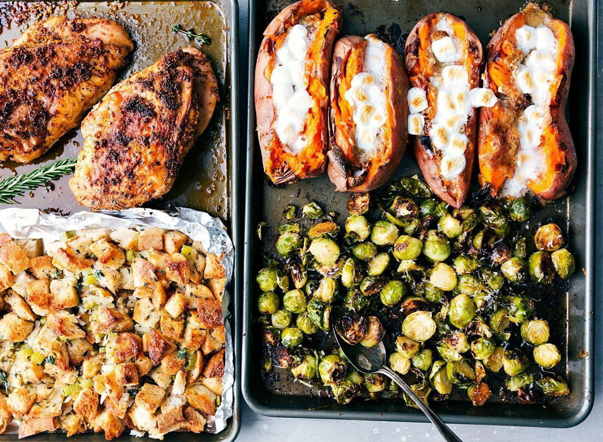 sheet pans with baked sweet potatoes brussels sprouts turkey breasts and stufing