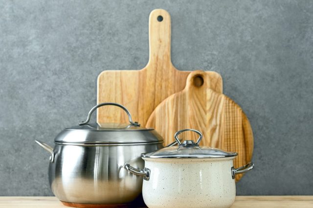 trendy cooking pots with lids and cutting boards