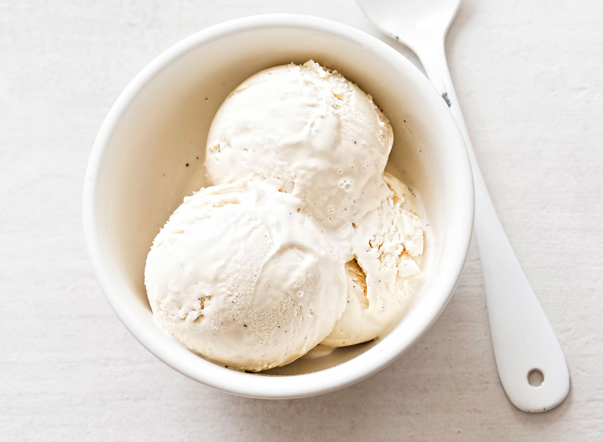 vanilla bean ice cream in white dish with spoon