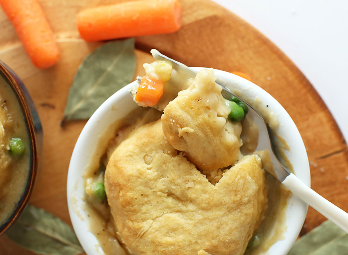 vegan pot pie with biscuit carrots and peas in mini serving bowl with whole baby carrots on the side