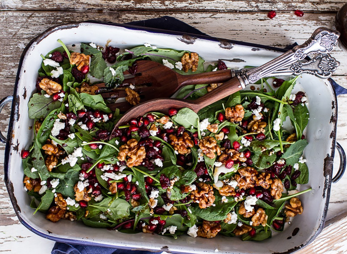 winter salad with spinach cranberries and candied walnuts in serving dish