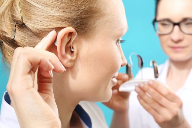 Hearing aid. The doctor assumes the woman hearing aid in your ear