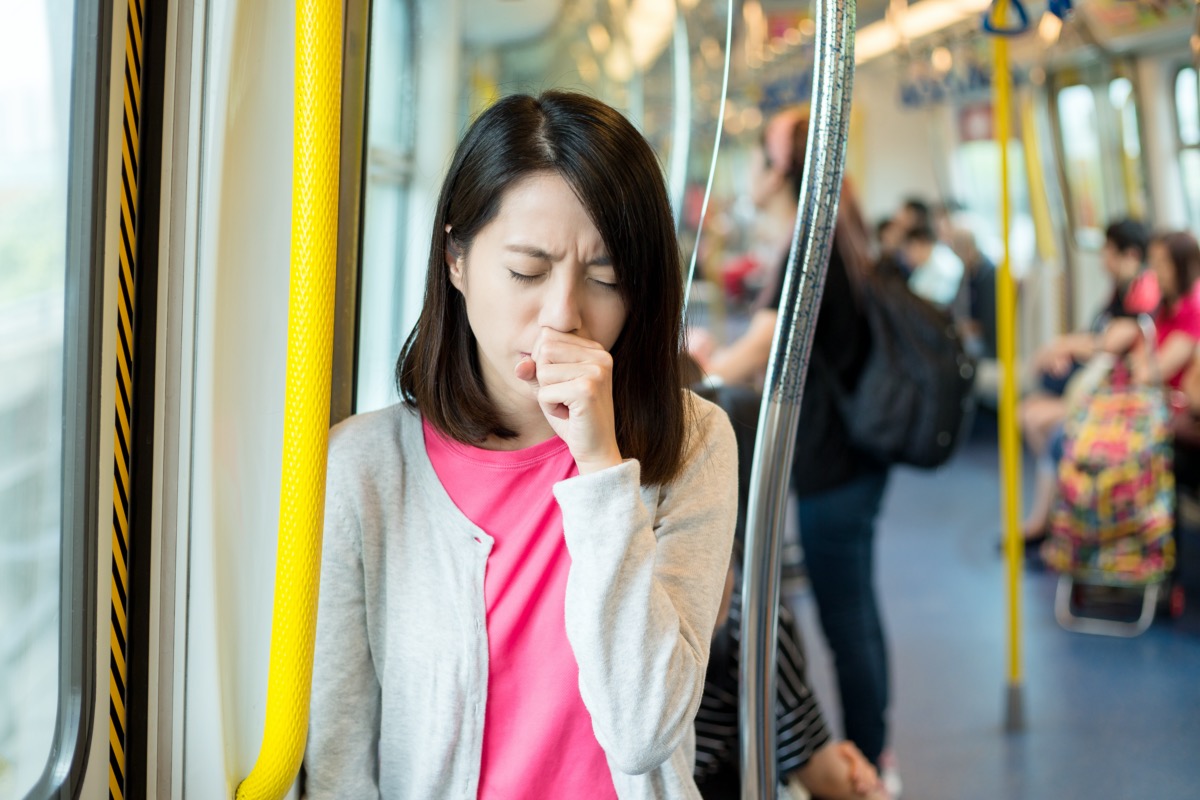 Woman feeling sick inside train compartment